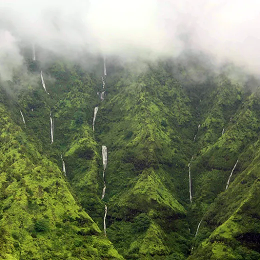 Passing rain showers feed the many waterfalls in Hanalei Valley