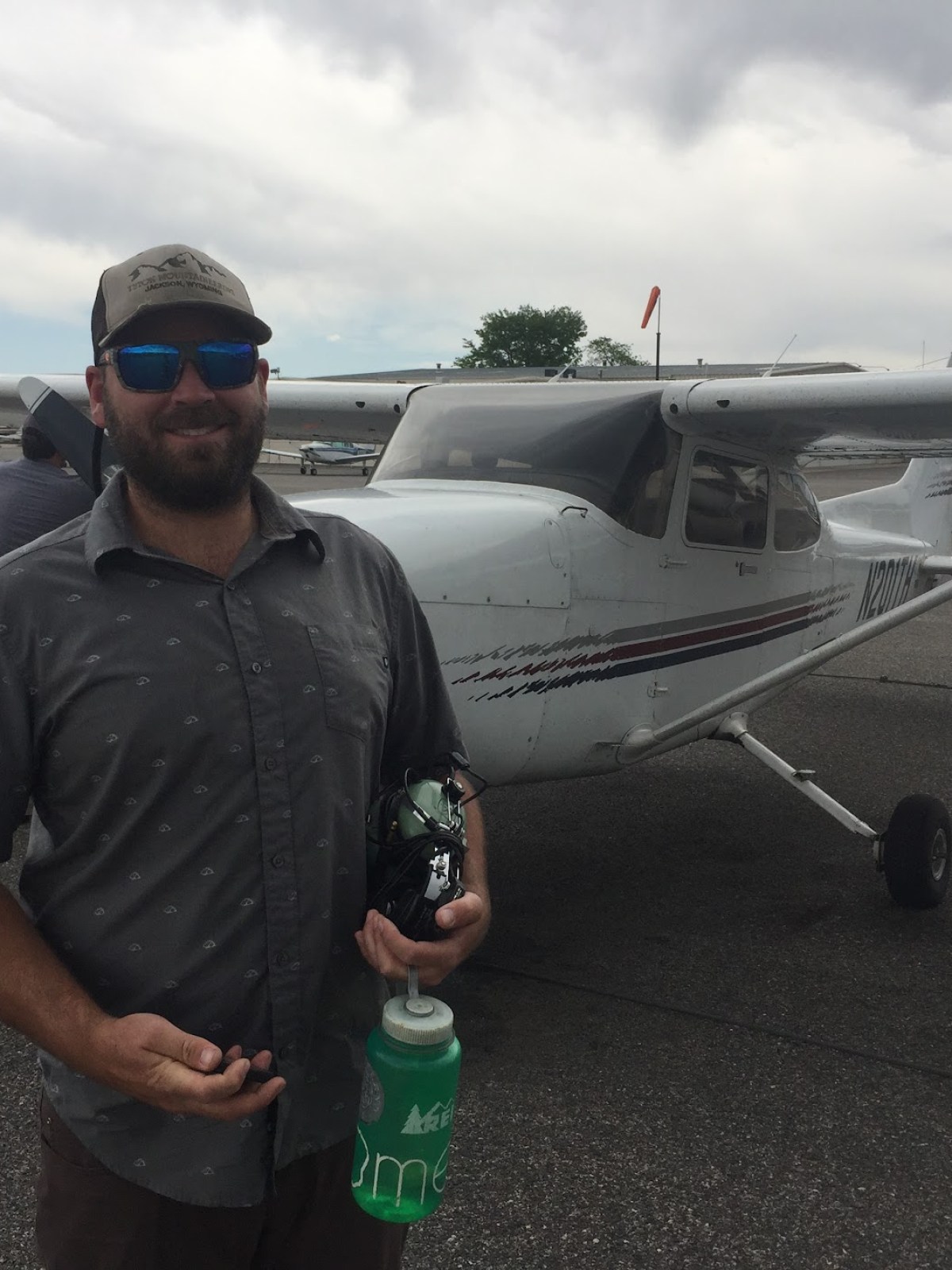 a man standing next to a plane